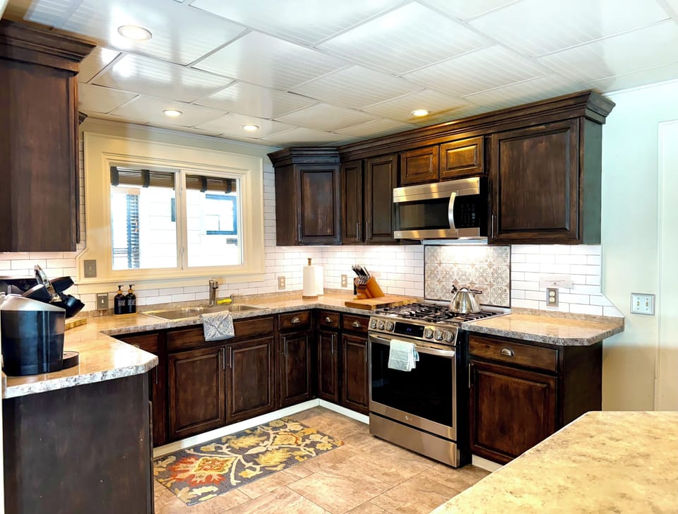 fully stocked kitchen with two sinks