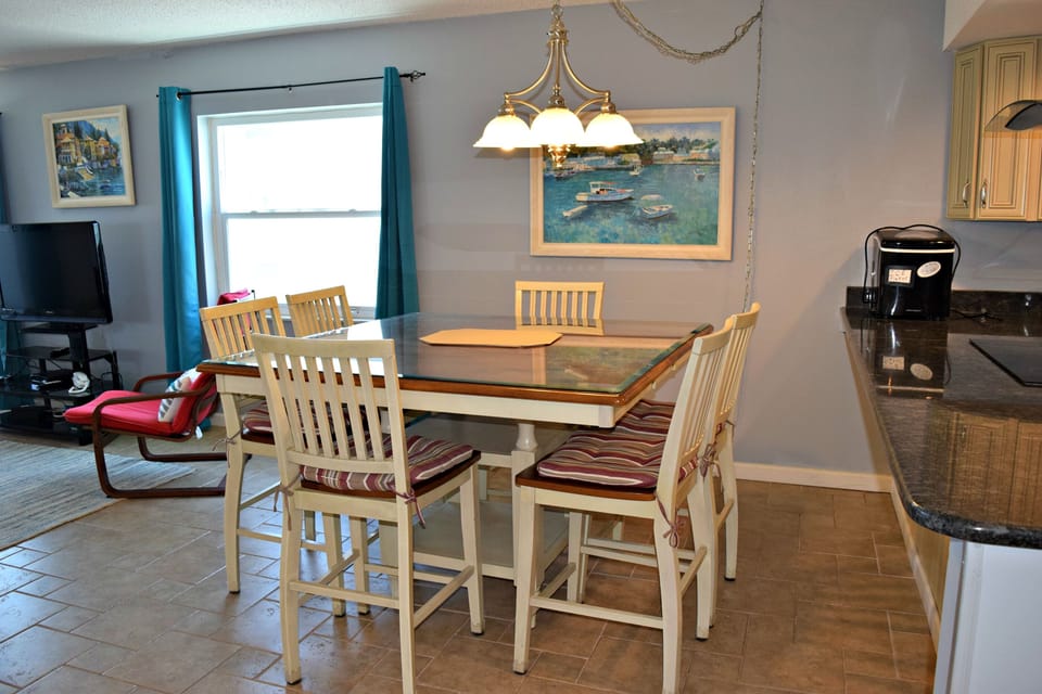 Between kitchen and living room is this large dining table, with a nice tile floor.