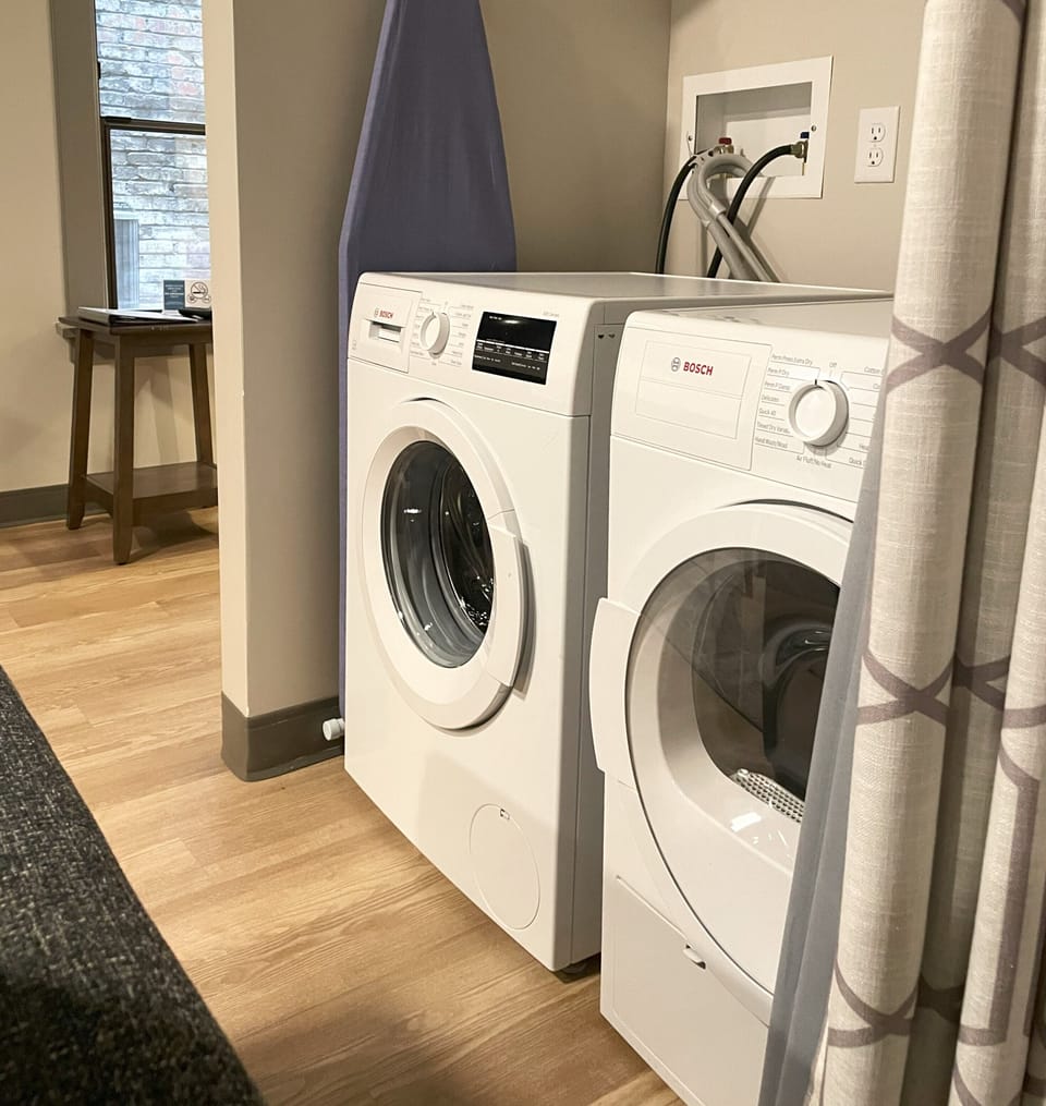 Washer and dryer in Apt. 208 with curtain open
