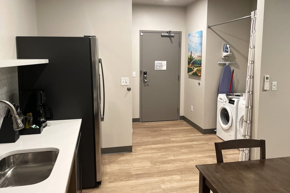 Entrance to apartment with washer and dryer shown