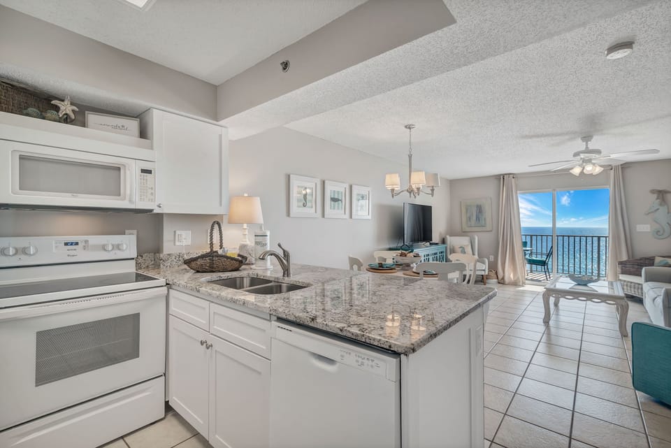 Gather, cook, and relax. Our stylish open living space features comfortable seating, a dedicated dining area, and a sleek, well-appointed kitchen for easy vacation living all with the views of the gulf!