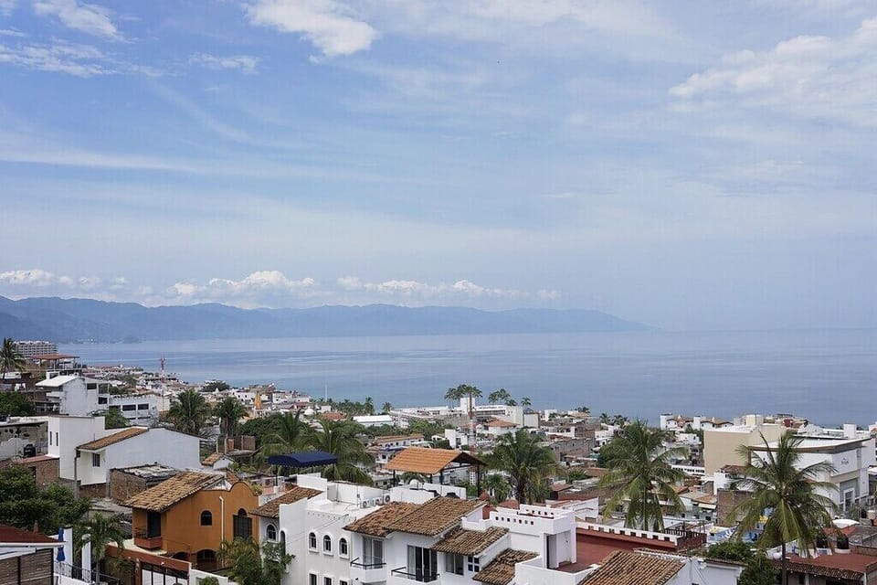 Rooftop Observation Deck: panoramic views of ocean, village & mountains behind
