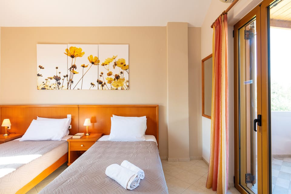 Twin bedroom with balcony access.
