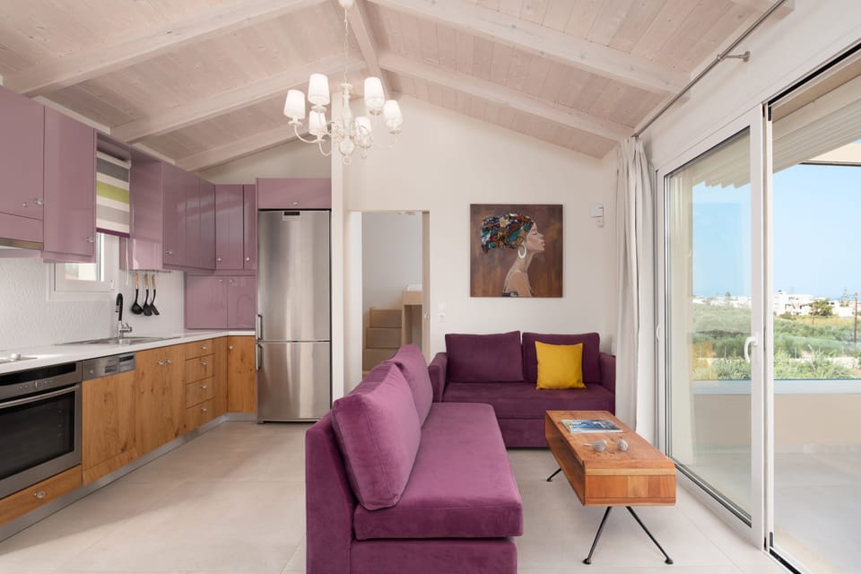 The First floor living room & kitchen with a balcony filled with sea views.
