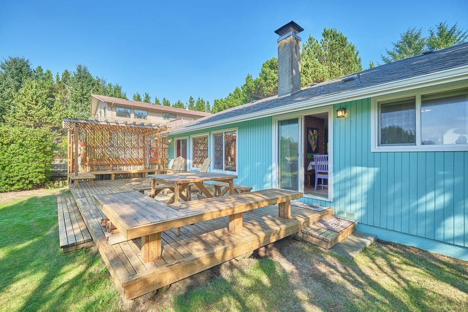 The large cedar deck with comfy Adirondack chairs and a picnic table offers a tranquil outdoor setting for this delightful retreat.