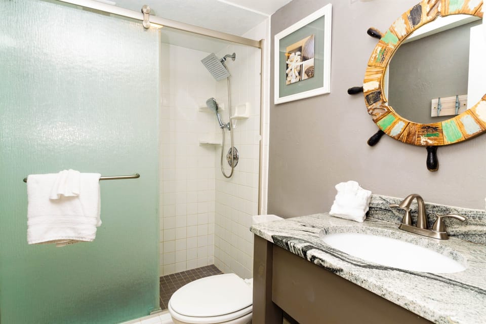 Full size bathroom with shower and vanity stocked with soft towels to use.