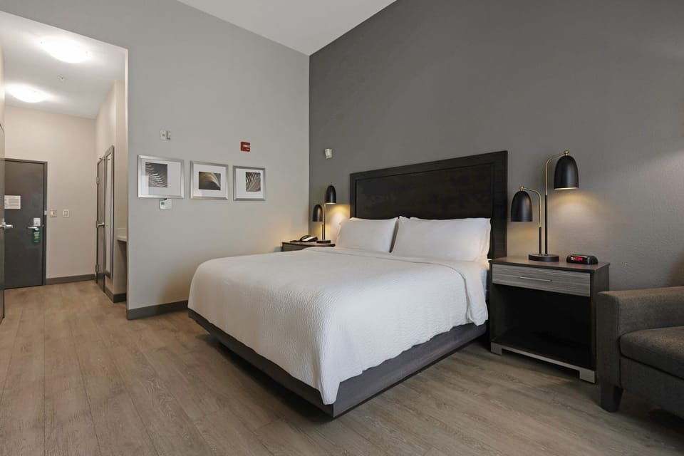 Premium bedding, desk, laptop workspace, blackout drapes