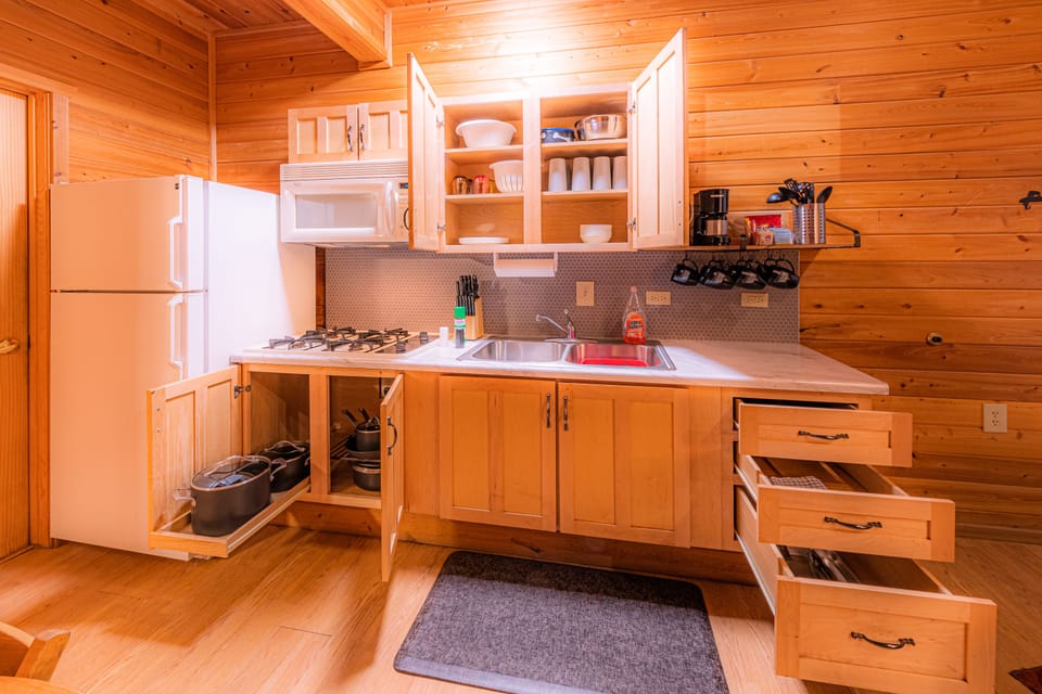 Kitchen with pots pans cutlery bowls plates cups etc