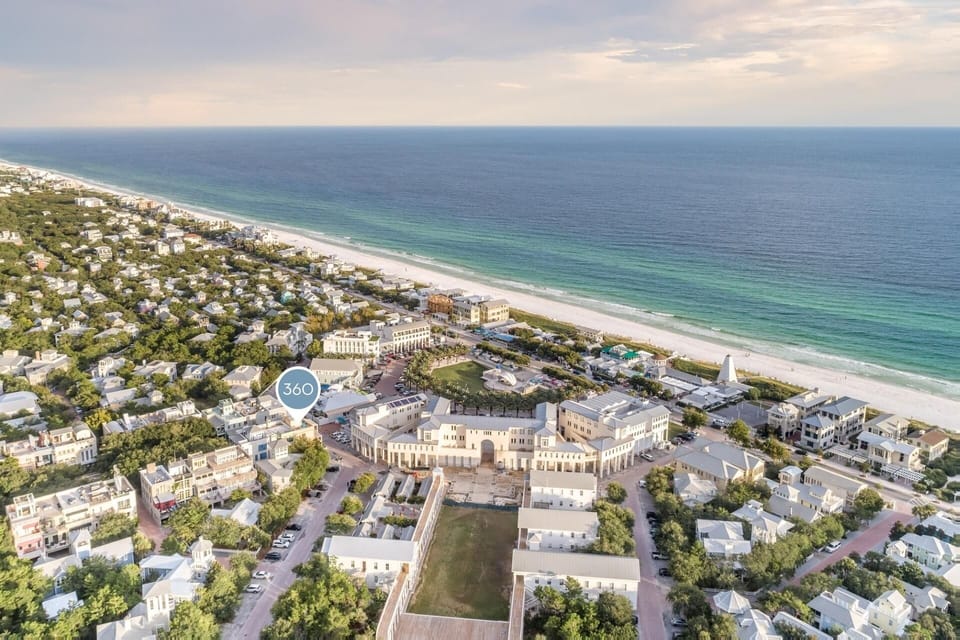 Aerial view showcasing the coastal community and pristine beaches surrounding the property, just steps from the emerald Gulf waters.