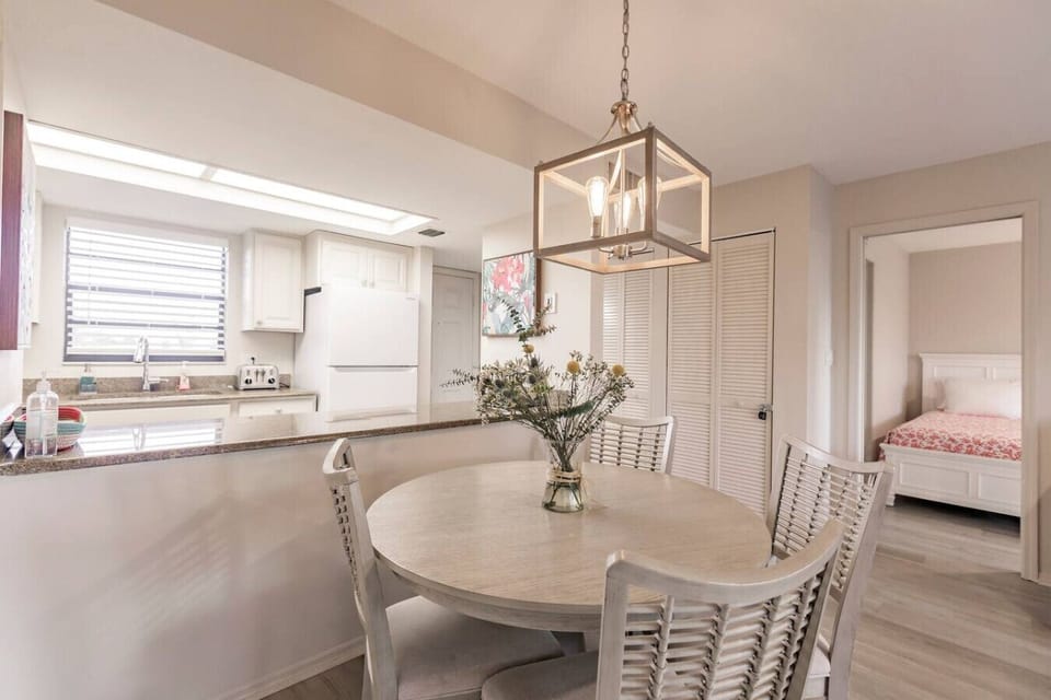 Dining area looking into kitchen and 2nd bedroom in background.