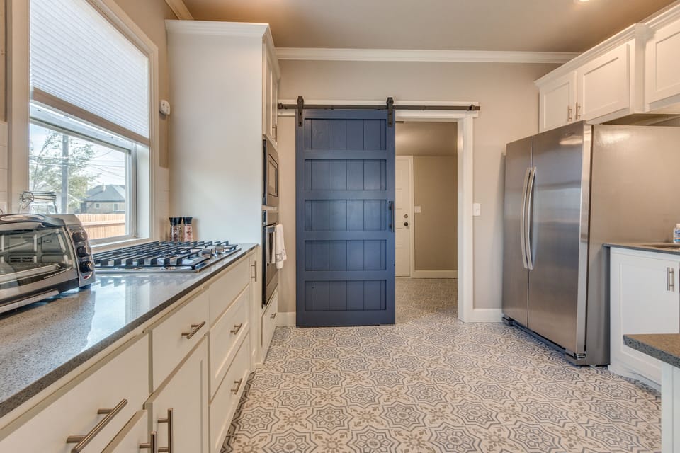 kitchen looking into laundry room beyond the barn door
