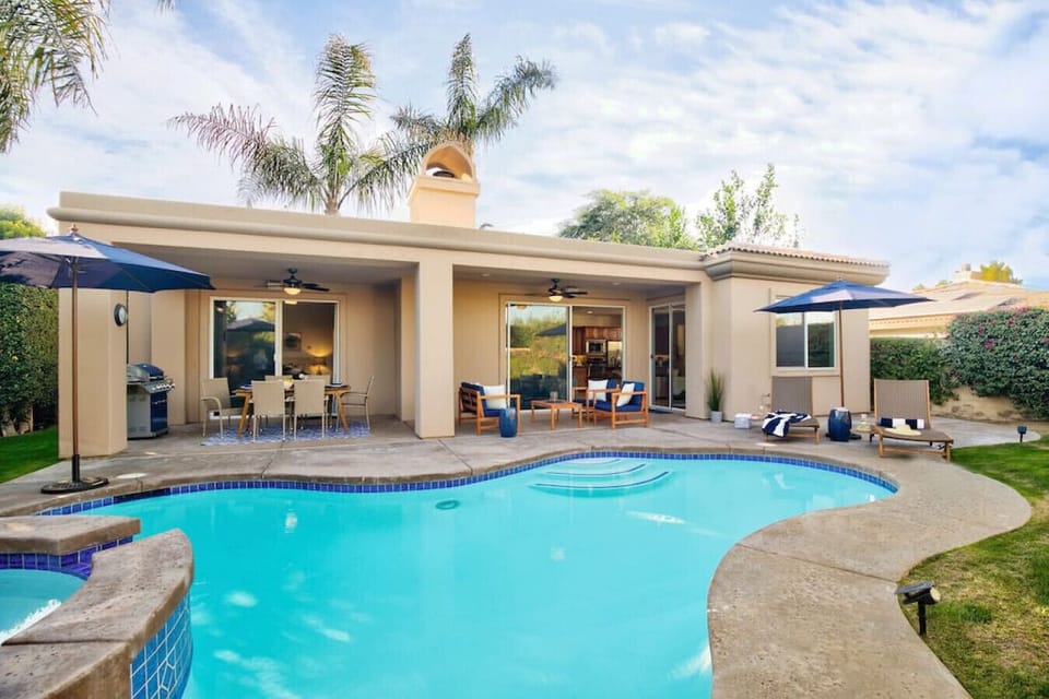 Heated pool/spa, market umbrellas, lounge seating, dining area, fire table & BBQ