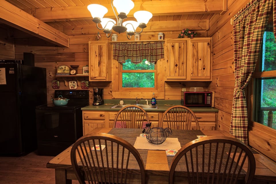 The kitchen has modern amenities, including a stove, refrigerator, toaster, coffee maker, microwave, and all the tools needed to cook romantic dinners together.