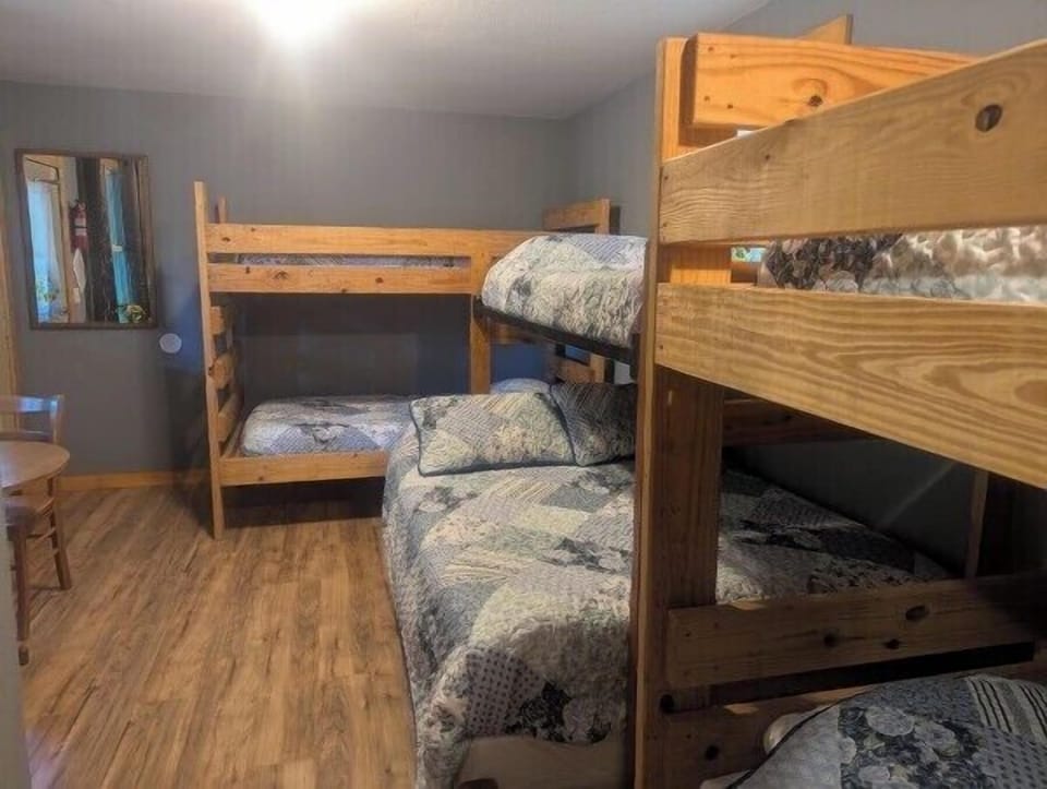MAIN ROOM:  The main room, which features 6 beds (5 twins and 1 double), a small dining table, and a small sink / kitchenette.