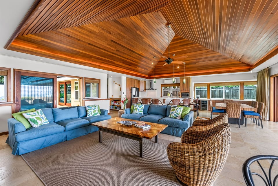Comfortable coastal furnishings open to the poolside terrace—perfect for entertaining or quiet relaxation.