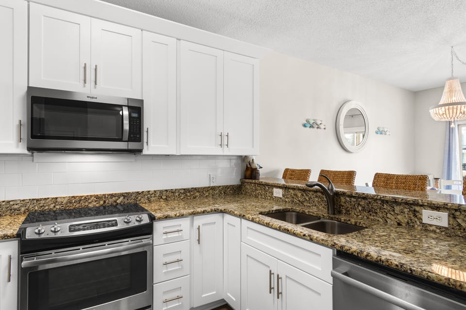 Your fully equipped kitchen awaits with granite counters, stainless appliances, and everything needed to create memorable meals during your stay.