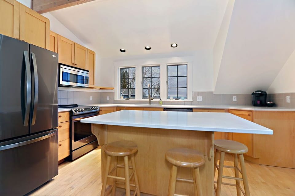 main house- kitchen with new stainless steel appliances and quartz countertops