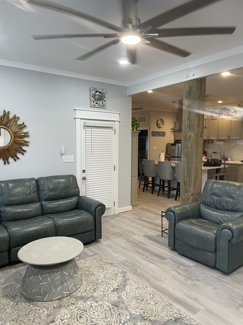 Automatic leather sofa and recliner in main living area.