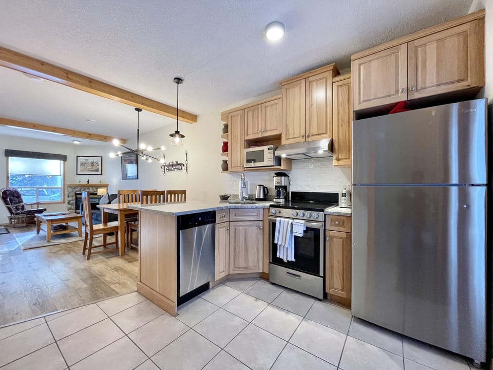 Newly upgraded kitchen with stainless steel appliances, marble counter top