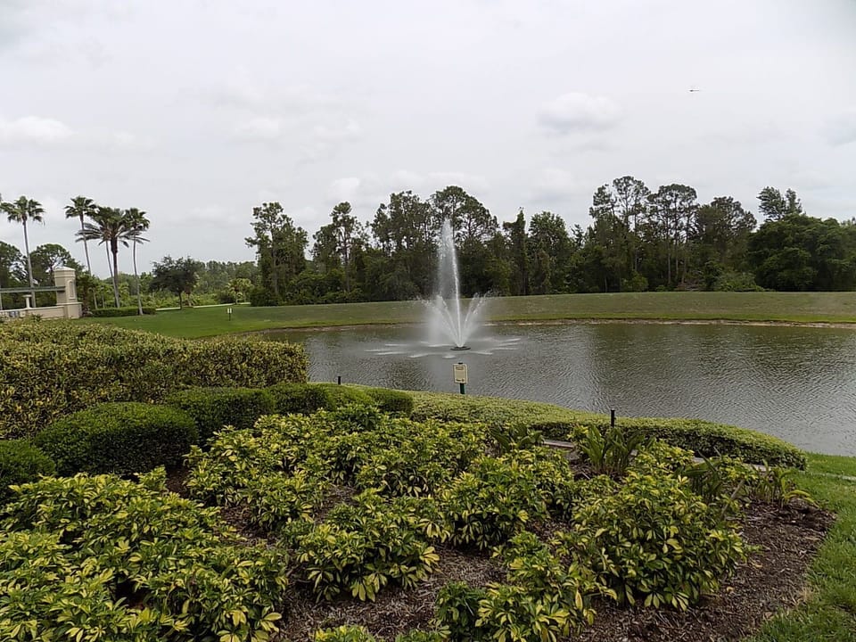 Nature pond with a fountain behind club house