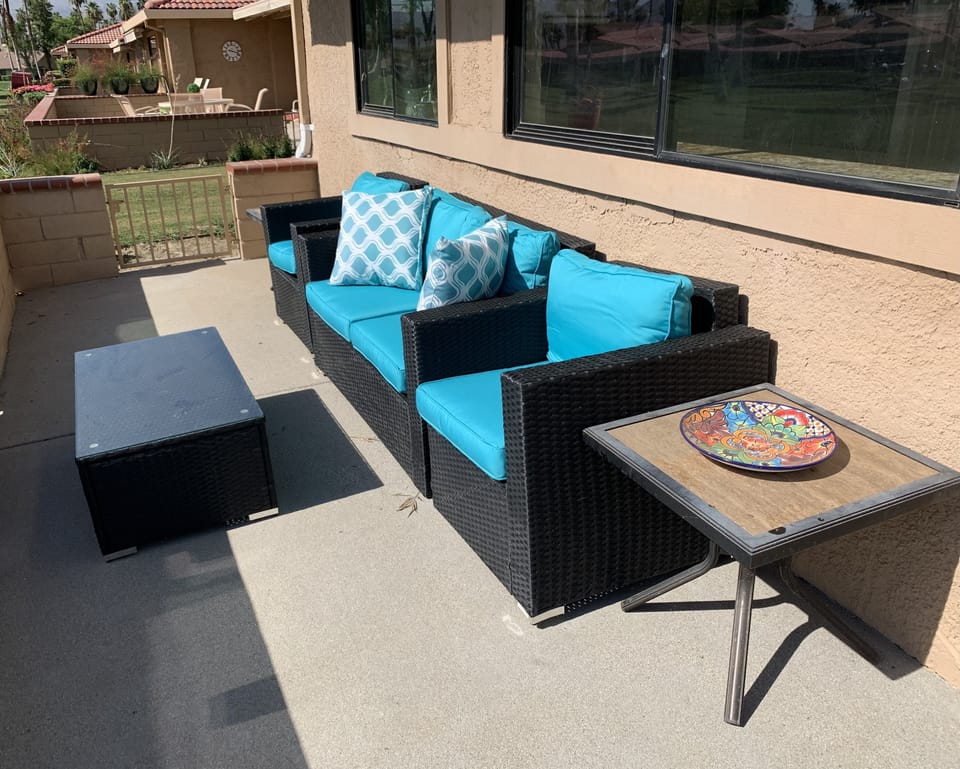 More back patio seating with retractable awning. Fire pit.