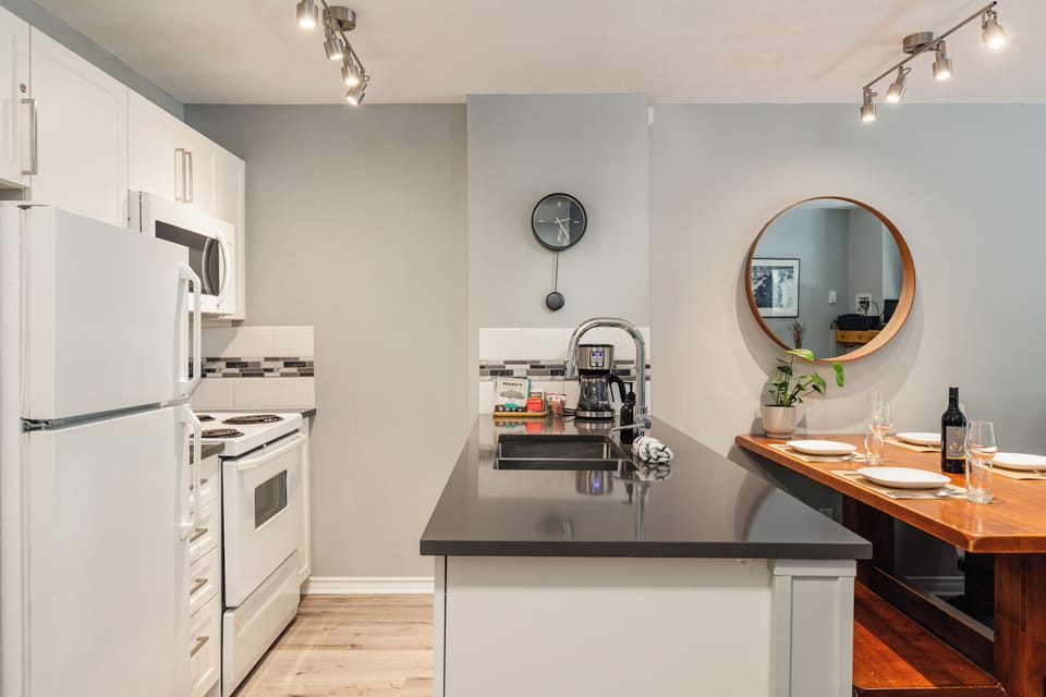 Full kitchen with modern cabinets and quartz countertops - ideal for home cooking.
