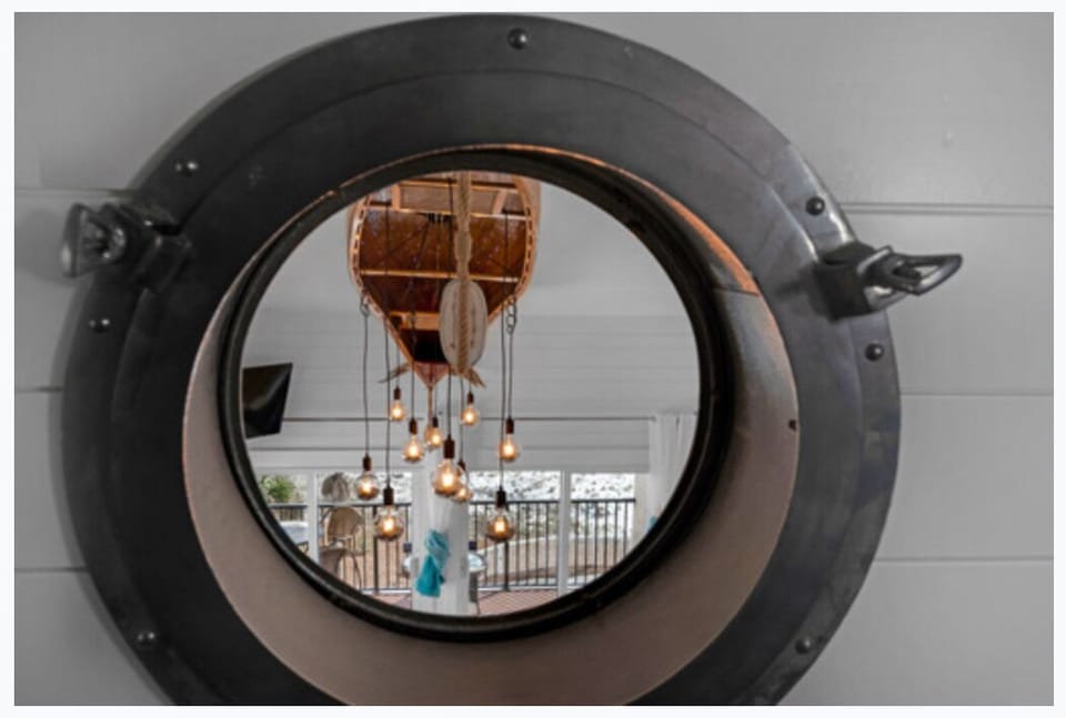 Port hole window from hallway bunk overlooking living room below