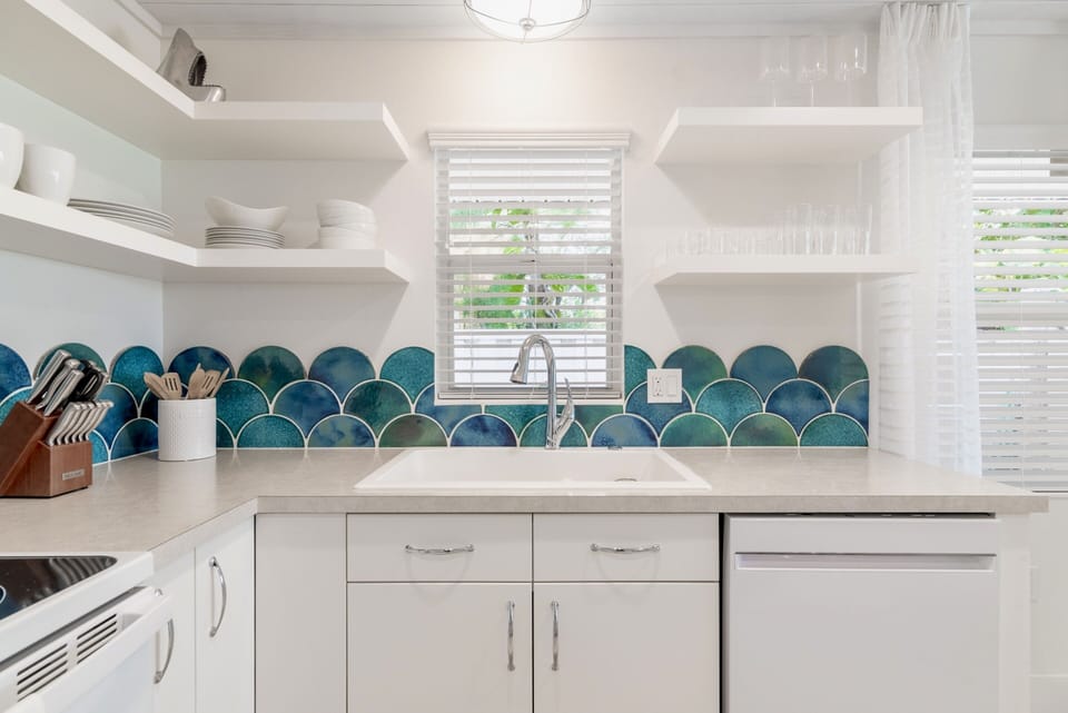 Watercolored handmade, hand glazed clay tiles are the focal point of the kitchen.