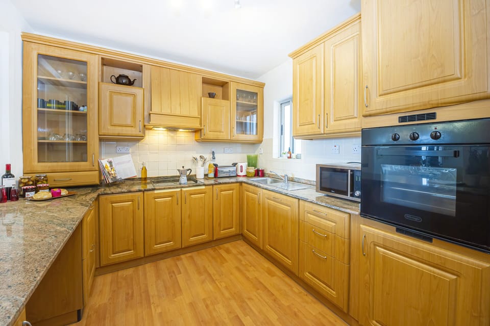 fully equipped kitchen with window overlooking the dining area