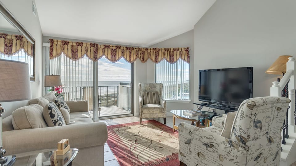 Large sliding glass doors open to a private balcony, bringing in natural light and extending the living space outdoors.
