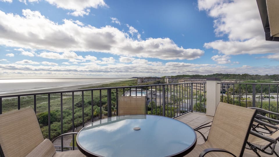 This stunning oceanfront view highlights the wide sandy shoreline and sparkling Atlantic waters just beyond the natural dune landscape.