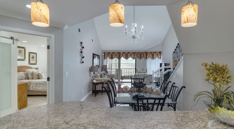 area is arranged for easy conversation and movie nights, while the open staircase adds architectural interest without interrupting the sightlines.
