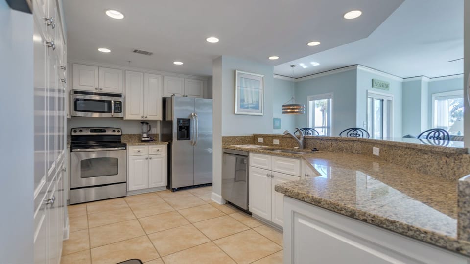 This bright, open kitchen is designed for both function and gathering. Recessed lighting keeps the space airy and inviting.