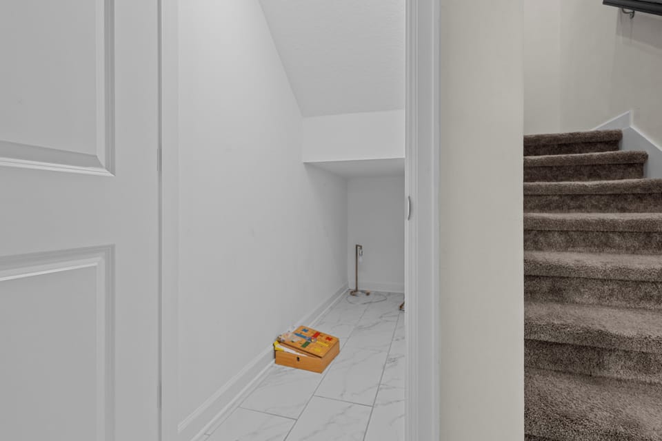 Your spacious under-stair storage offers convenient organization space, with easy tile flooring for effortless cleaning and maintenance.