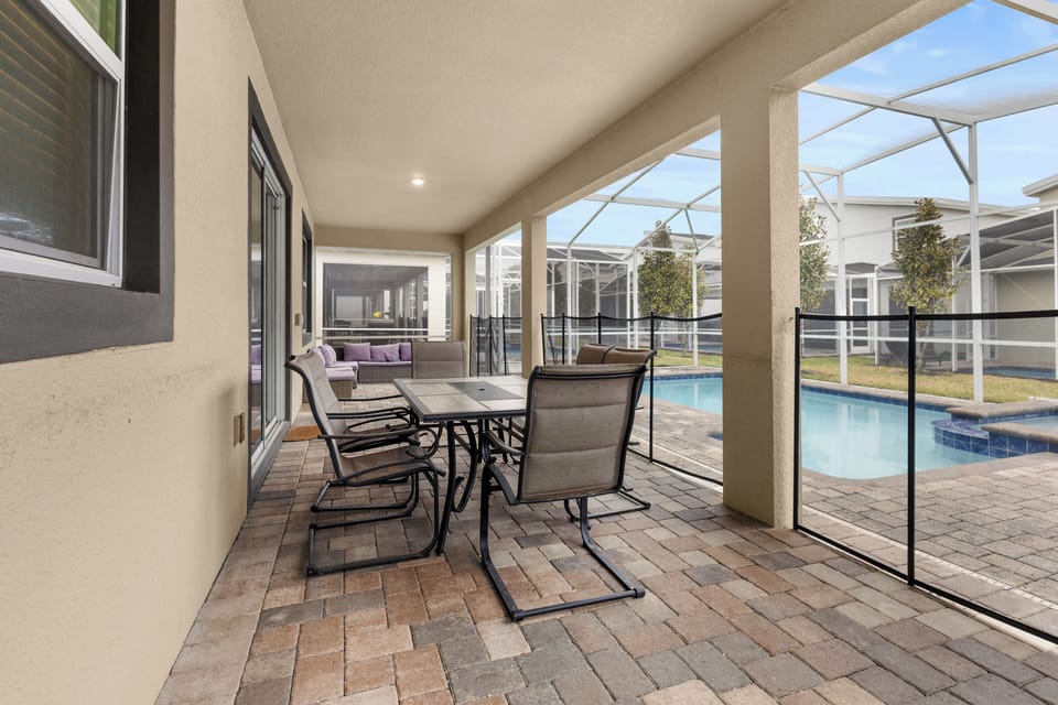 Relax on your private covered patio with poolside dining and lounge seating, perfect for morning coffee or evening gatherings.
