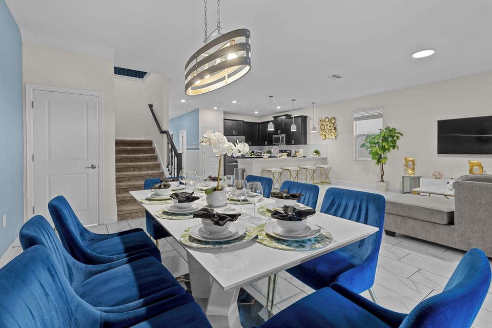 Gather around your elegant dining table with plush blue velvet chairs for memorable meals together.