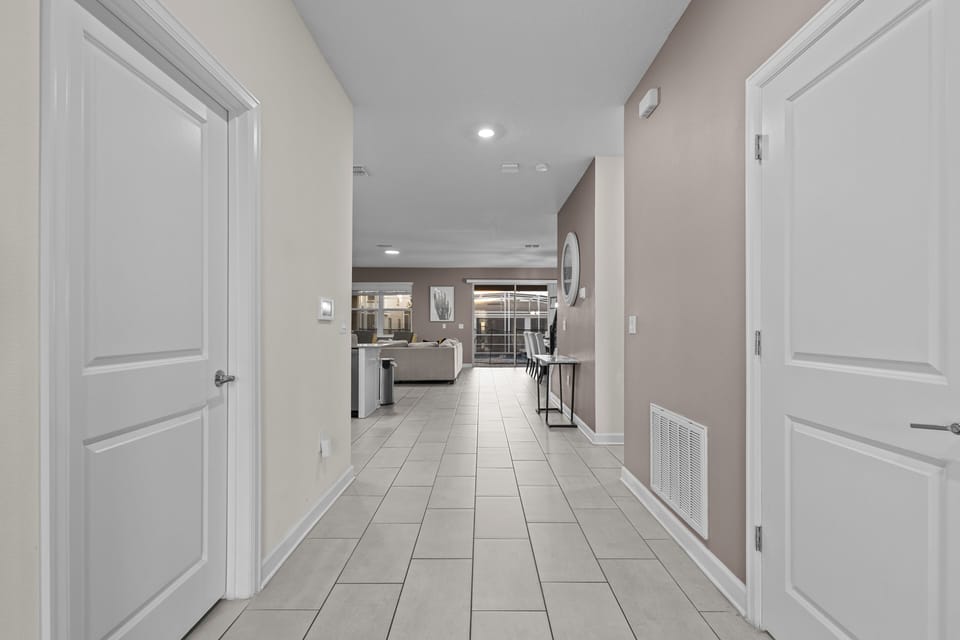 Step into your modern hallway where sleek tile floors lead to an inviting open-plan living space, perfectly designed for your comfort.