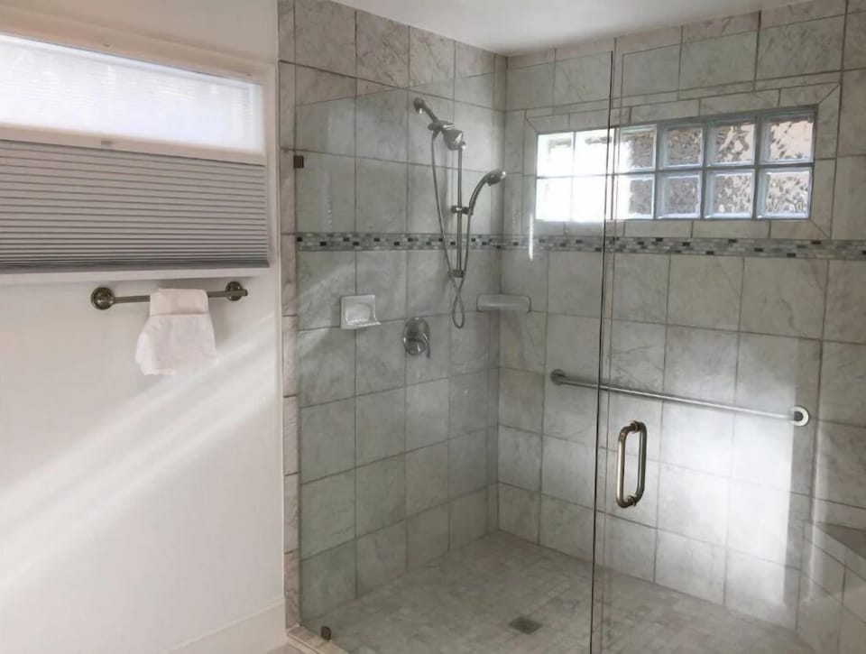 1F Mstr shower, walk/roll-in, 2 shower heads, built-in seat, wall bar. No tub.