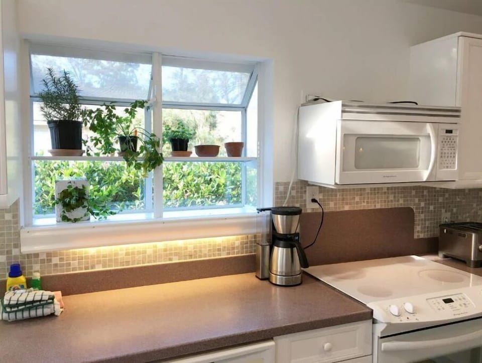 Sunny open kitchen, ground coffee maker and Keurig, water heater for tea, etc.