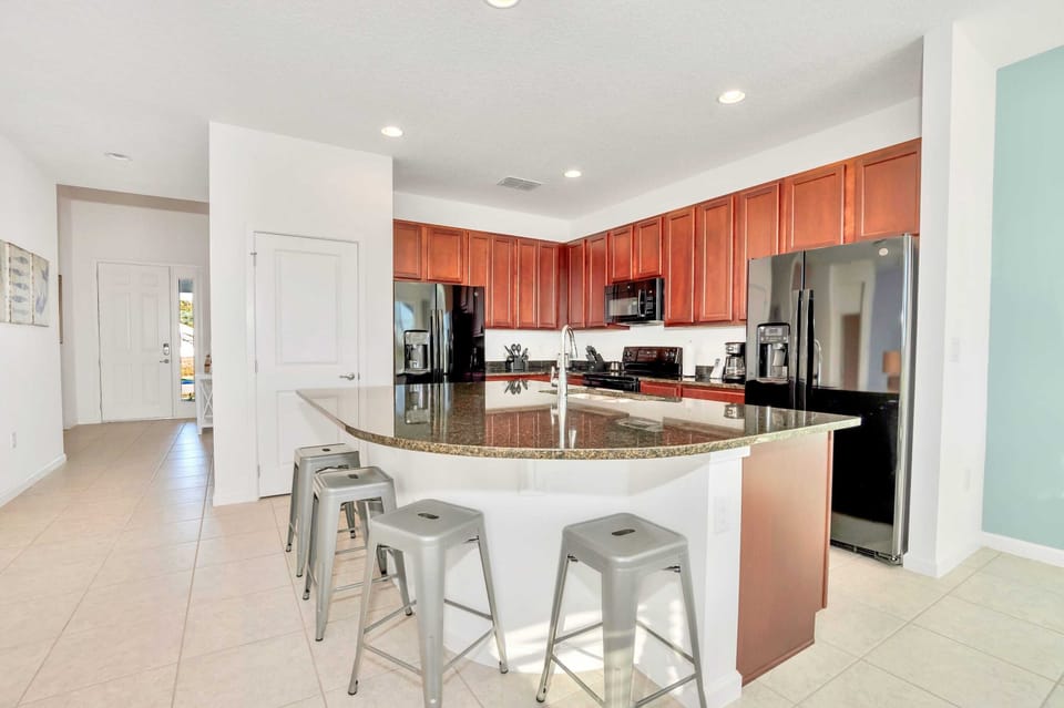 Fully Equipped Kitchen with Centered Island and Bar Stools