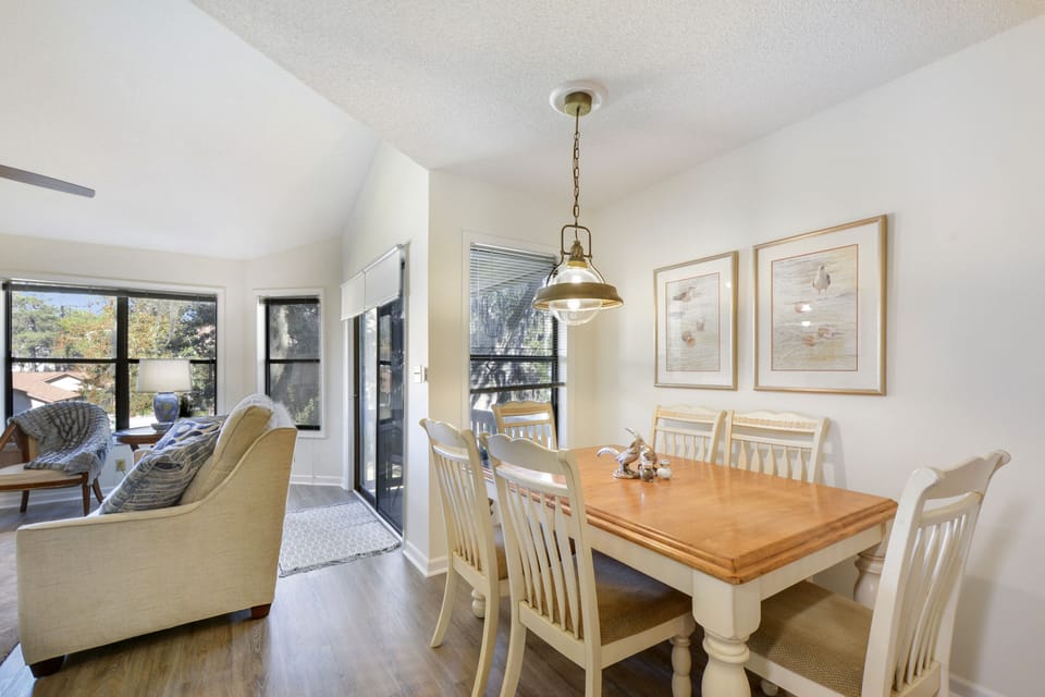 Dining Area and Balcony – Harbour Oaks 316, St. Simons - The dining area at Harbour Oaks 316 opens to a private balcony and sunlit living space. Perfect for morning coffee before exploring St. Simons Island.