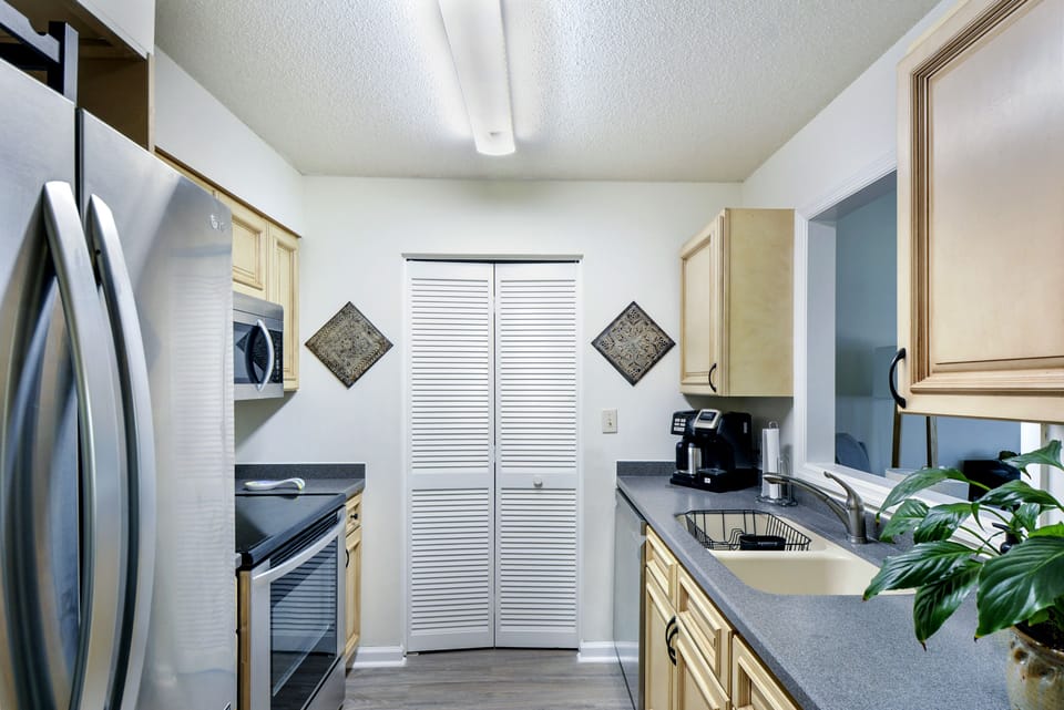 Full Kitchen – Harbour Oaks 316, St. Simons Island - Spacious, fully stocked kitchen at Harbour Oaks 316 with updated appliances, plenty of counter space, and everything you need for a home-cooked meal on vacation.