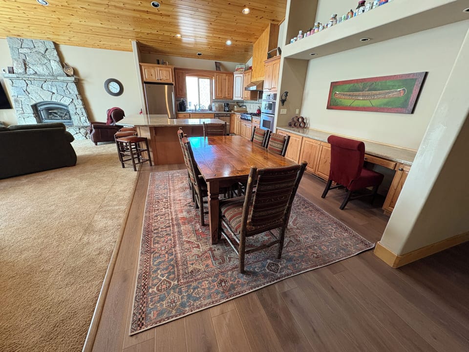 Spacious dining table set on brand new rustic laminate floors, seamlessly connecting to the kitchen and great room for effortless entertaining.