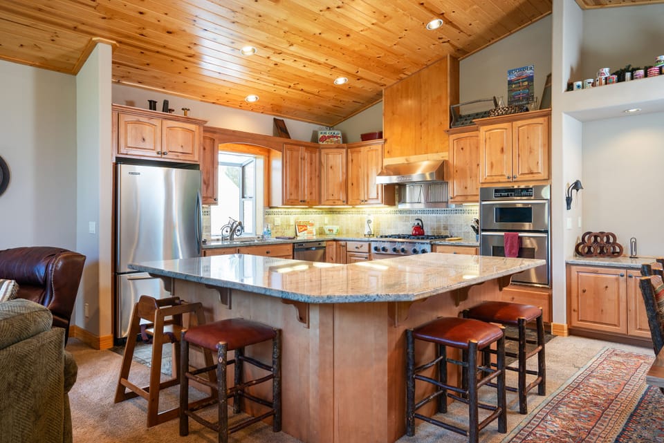 Spacious kitchen with chef-grade appliances, granite countertops, and a breakfast bar—everything you need to create your favorite meals.