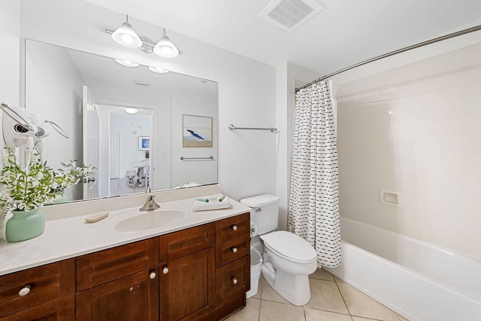 Unwind in your pristine bathroom featuring a soaking tub, stylish vanity, and fresh coastal touches that make your daily routine feel like a spa retreat.