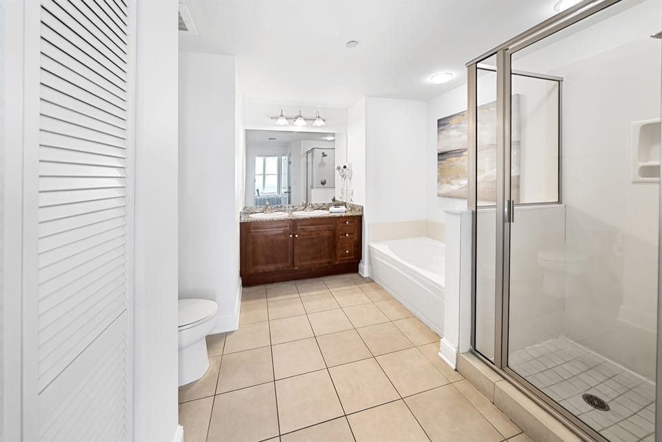 Your spacious bathroom features both a relaxing soaking tub and separate glass-enclosed shower, perfect for unwinding after your adventures.