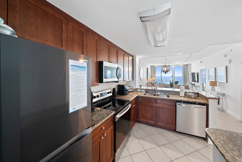 Your fully equipped kitchen features granite countertops, stainless steel appliances, and stunning ocean views for memorable meal preparation.