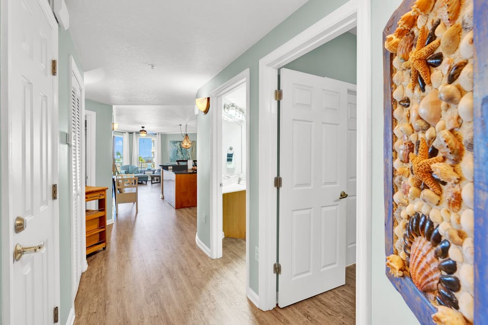 Step into your coastal haven where soothing mint walls and warm wood floors create the perfect beach retreat atmosphere.