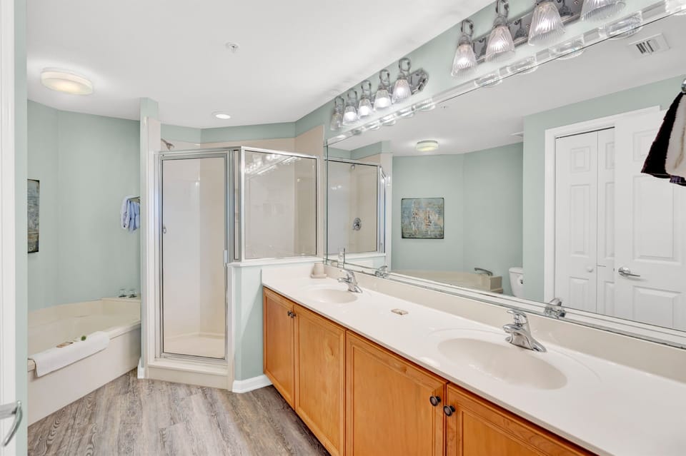 Your spacious master bathroom features dual vanities, walk-in shower, and soaking tub for ultimate relaxation and convenience.