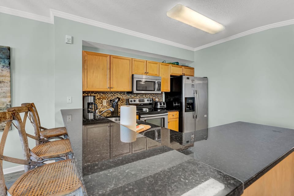 Your well-appointed kitchen features granite countertops, stainless steel appliances, and warm wood cabinets with everything you need for home cooking.